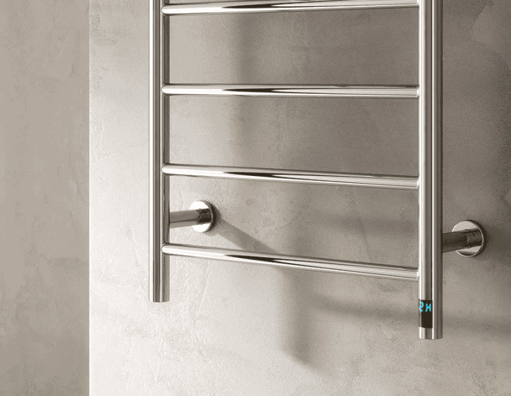 Chrome wall mounted towel rail radiator installed vertically in a bathroom