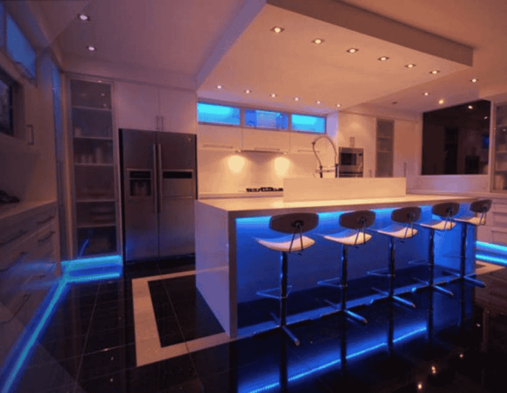 Modern style kitchen illuminated with blue LED mood lighting strips and ceiling LED downlighters